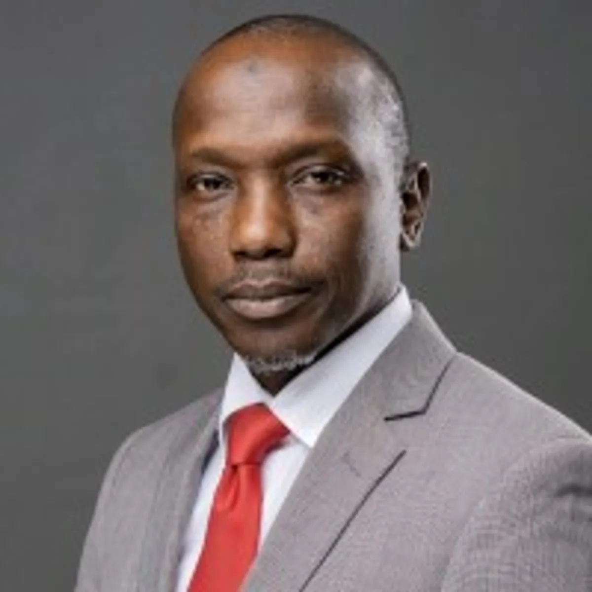 woman in brown coat using macbook air