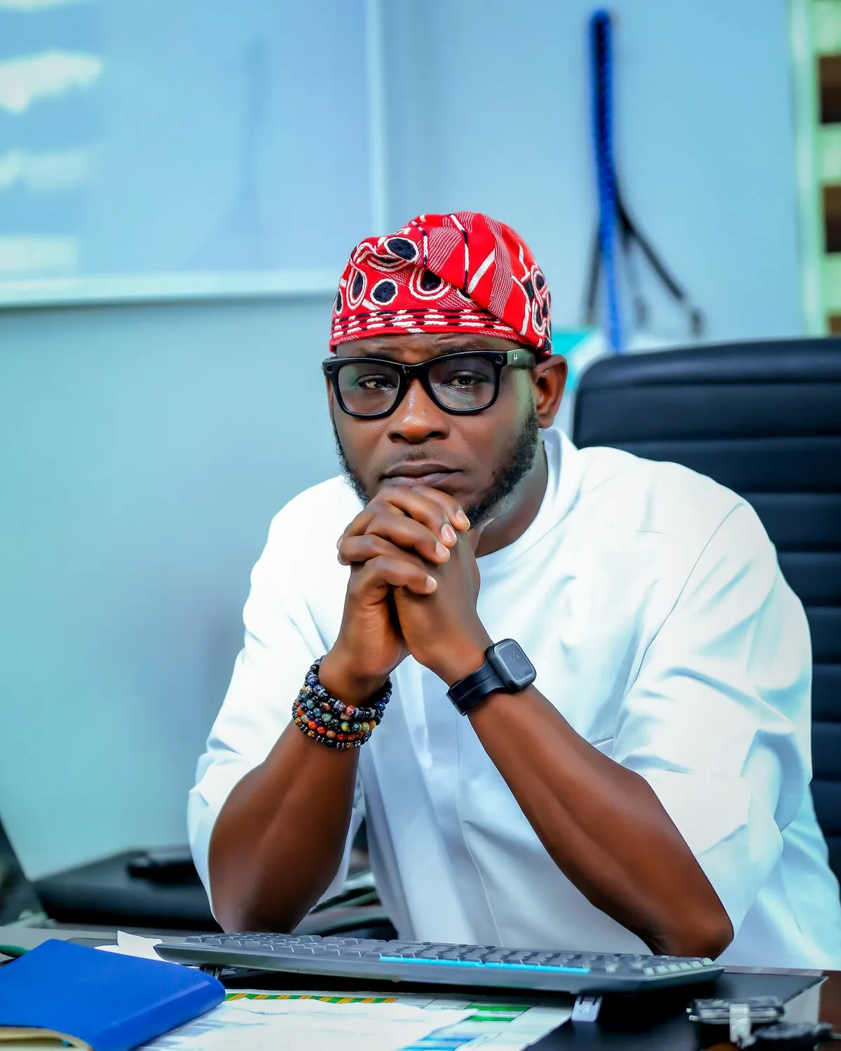 man in black formal suit jacket and pants carrying black bag while walking on pedestrian lane during daytime